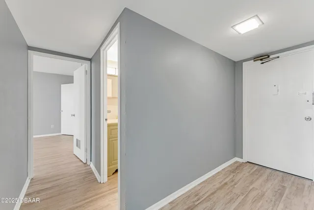 a view of hallway with wooden floor