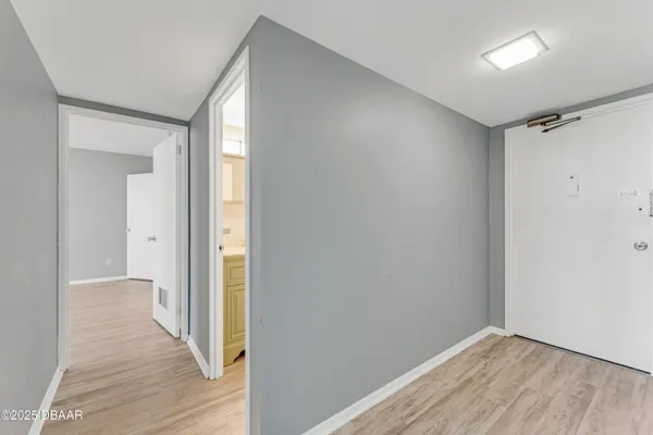 a view of hallway with wooden floor