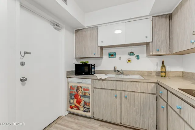 a kitchen with appliances a sink and cabinets