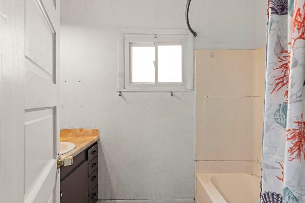 405 7th Street Fowler, CO 81039 - Photo 12 of 25 a bathroom with a tub sink and mirror