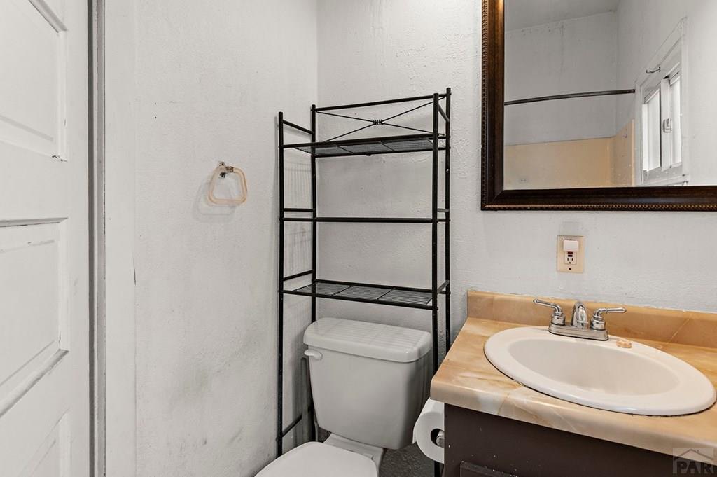 405 7th Street Fowler, CO 81039 - Photo 13 of 25 a bathroom with a sink toilet and mirror
