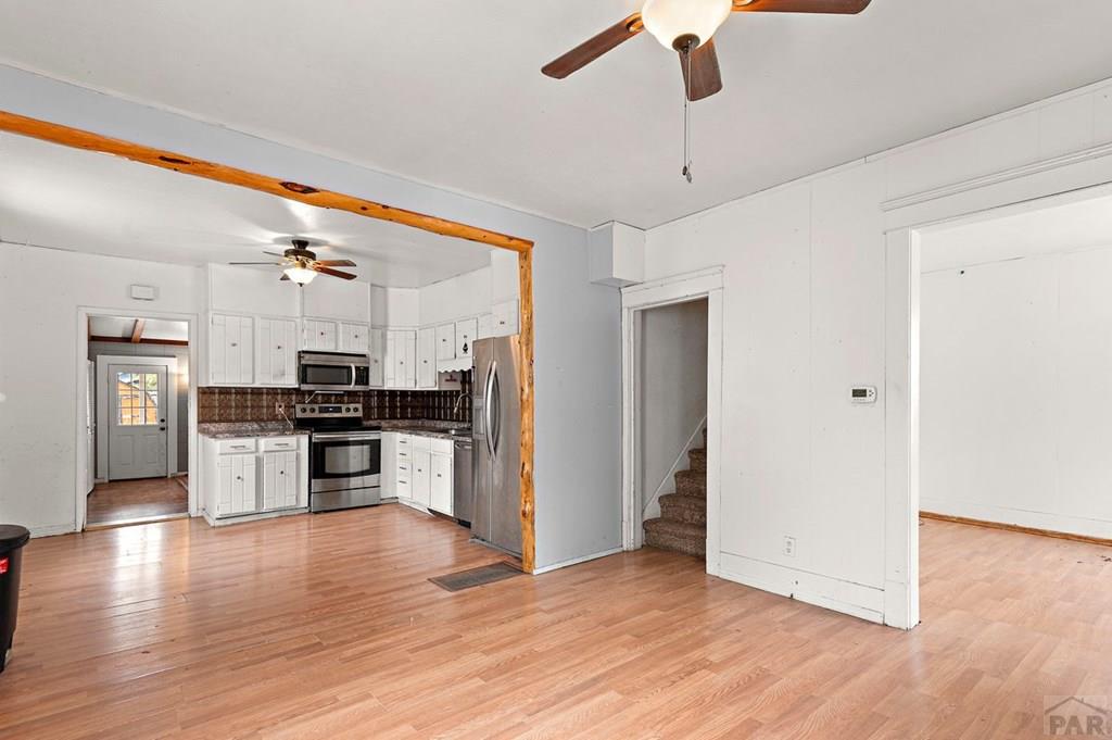 405 7th Street Fowler, CO 81039 - Photo 3 of 25 a kitchen with stainless steel appliances kitchen island granite countertop a refrigerator and a stove top oven