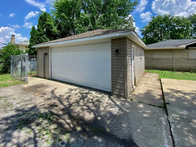 a front view of a house with yard and trees