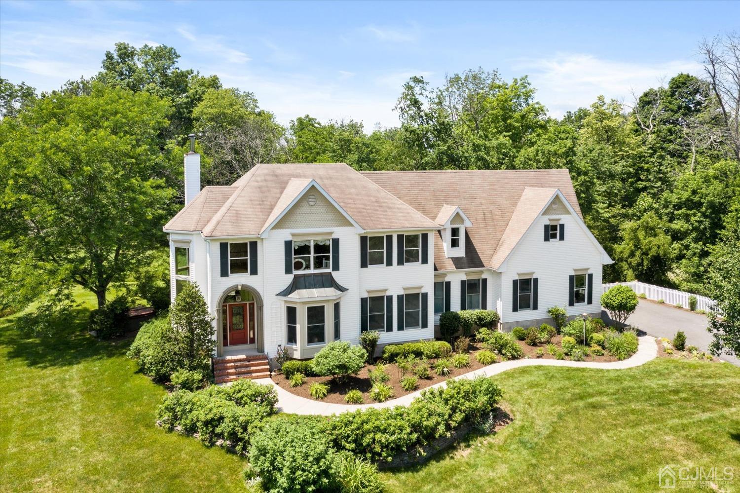 2 Old Mill Road Pennington, NJ 08534 - Photo 1 of 45 a aerial view of a white house with a yard table and chairs
