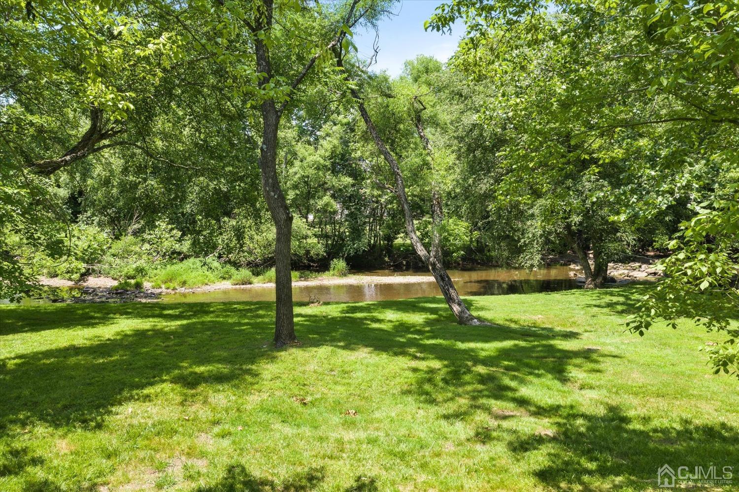 2 Old Mill Road Pennington, NJ 08534 - Photo 4 of 45 a swimming pool with lots of tress in front of it