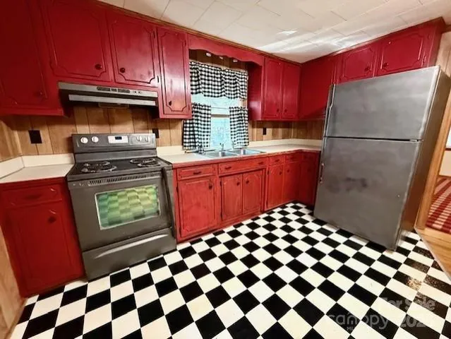 a kitchen with a stove a refrigerator and a sink