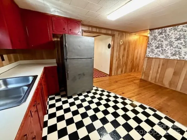 a kitchen with a refrigerator and a sink