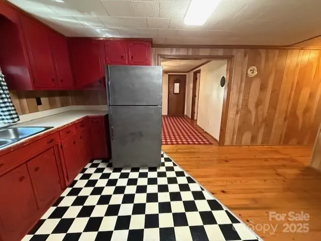a kitchen with a refrigerator and a sink