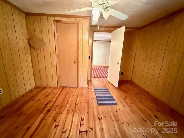 a view of a room with wooden floor and staircase