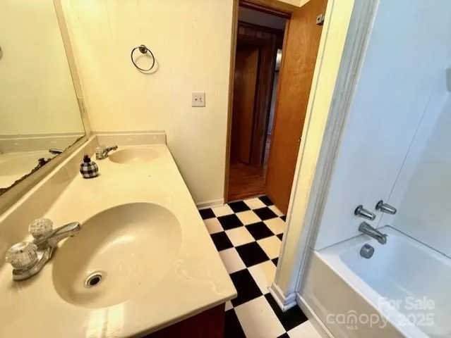 a bathroom with a tub and a sink