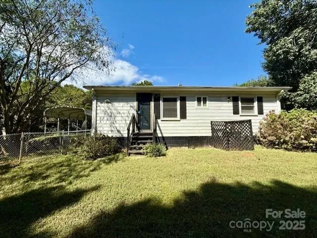 a view of a house with backyard swimming pool and sitting area