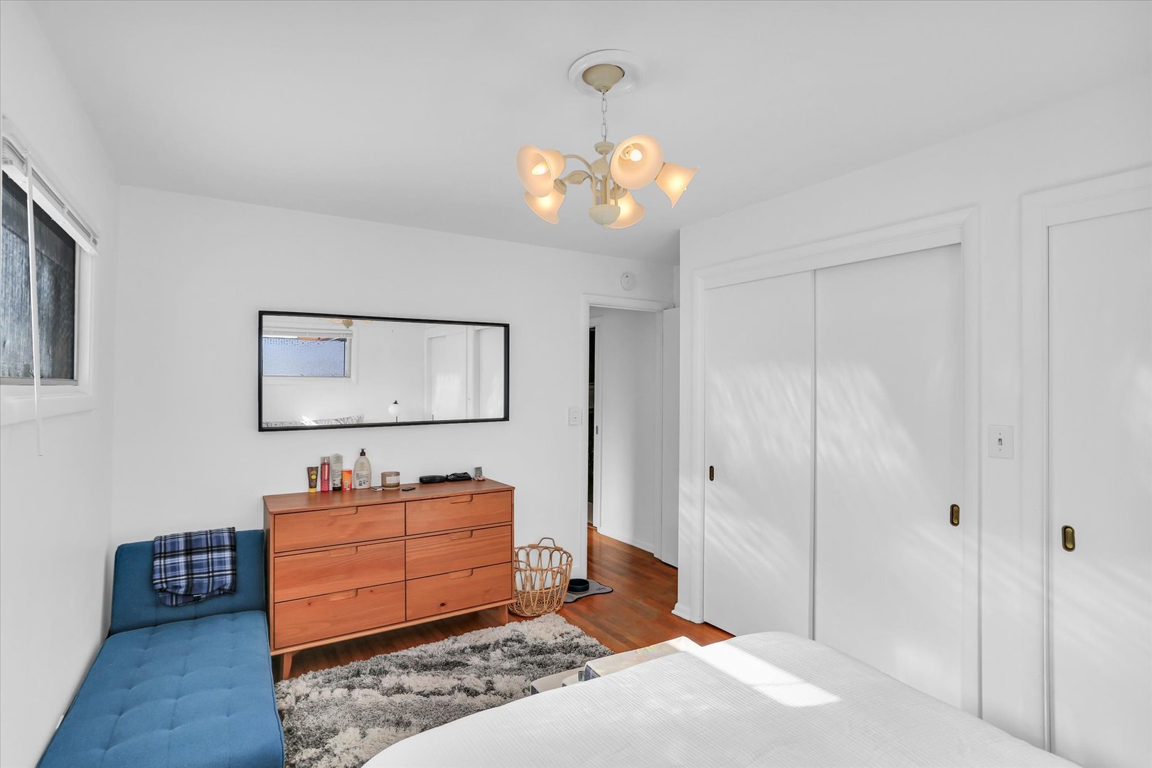 913 West Union Street Champaign, IL 61821 - Photo 22 of 32 a bedroom with a dresser and a chandelier