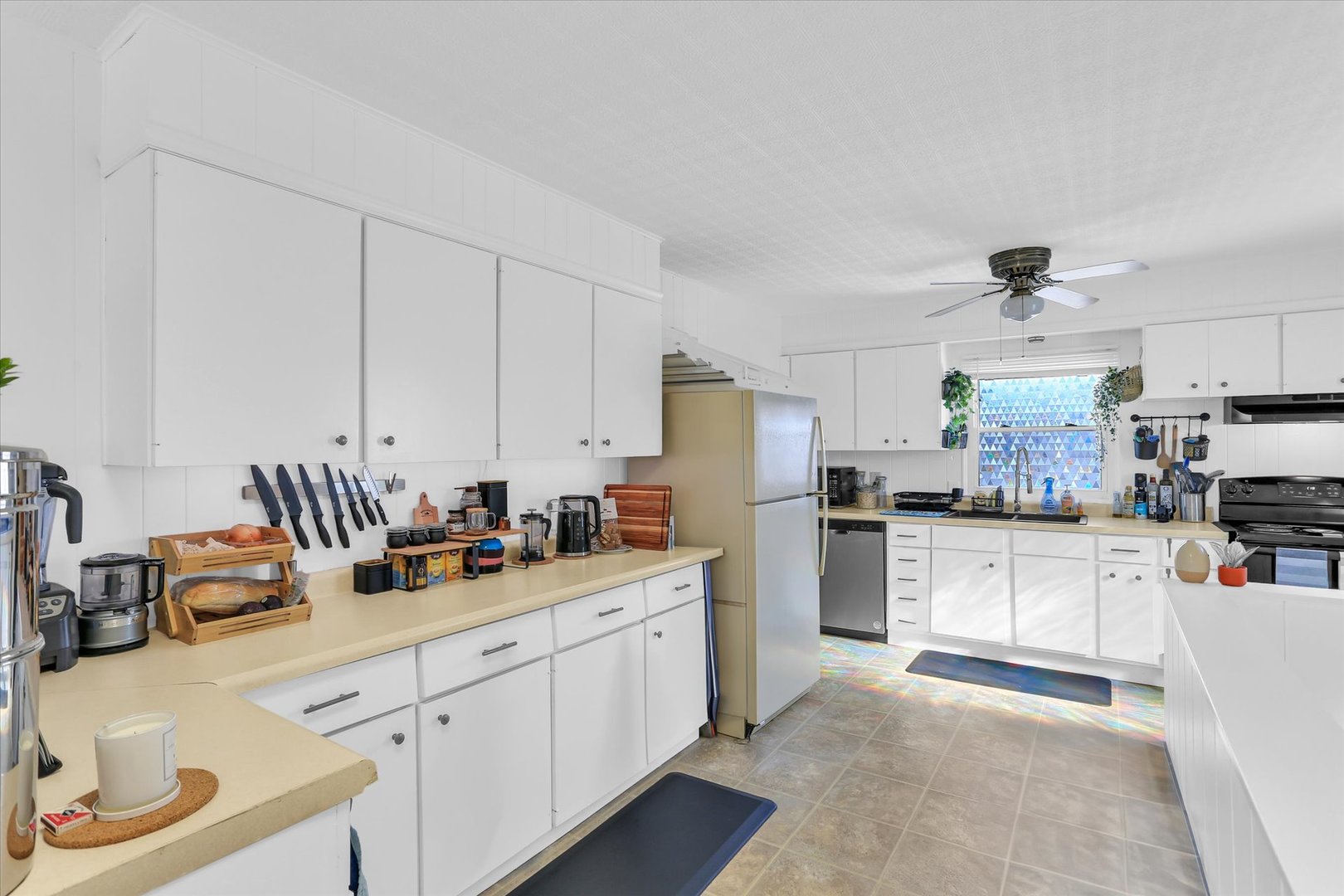 913 West Union Street Champaign, IL 61821 - Photo 7 of 32 a kitchen with white cabinets and appliances