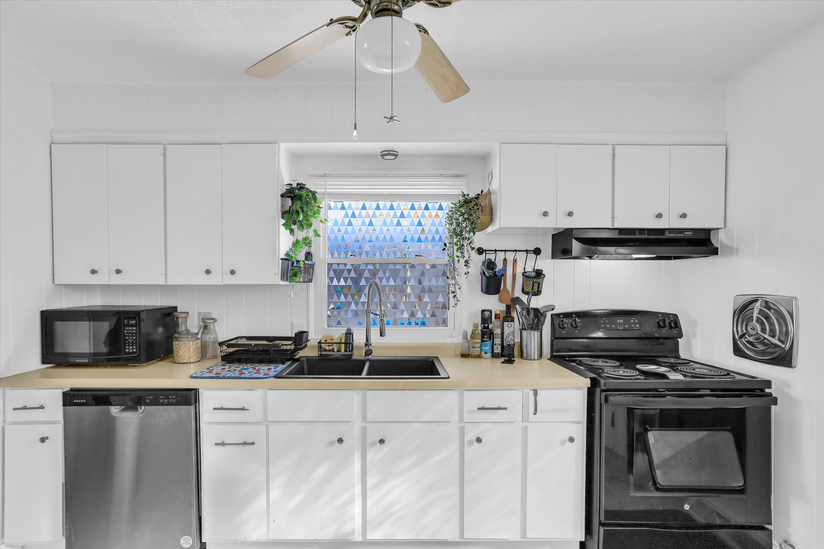 913 West Union Street Champaign, IL 61821 - Photo 8 of 32 a kitchen with stainless steel appliances granite countertop white cabinets a stove a sink and dishwasher