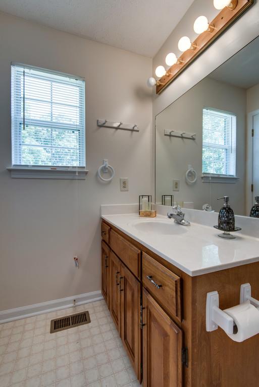 931 Hargrove Road West Dickson, TN 37055 - Photo 21 of 23 a bathroom with a sink a mirror and a window