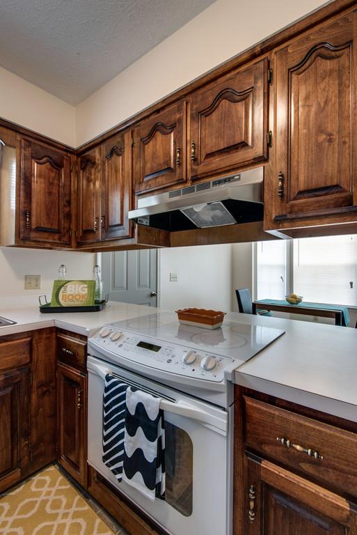 931 Hargrove Road West Dickson, TN 37055 - Photo 8 of 23 a kitchen with stainless steel appliances granite countertop a stove a sink and cabinets
