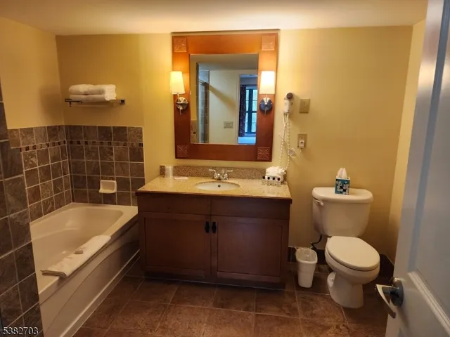 a kitchen with granite countertop a sink cabinets and stainless steel appliances