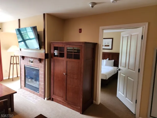 an aerial view of residential house with outdoor space and trees all around