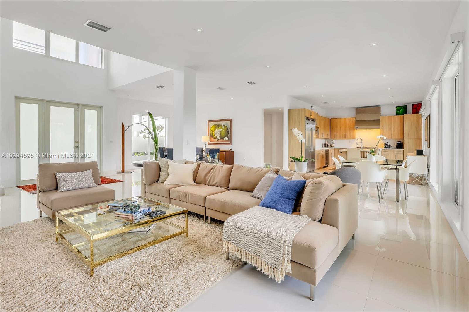 12565 Palm Road North Miami, FL 33181 - Photo 11 of 75 a living room with furniture potted plant and a large window