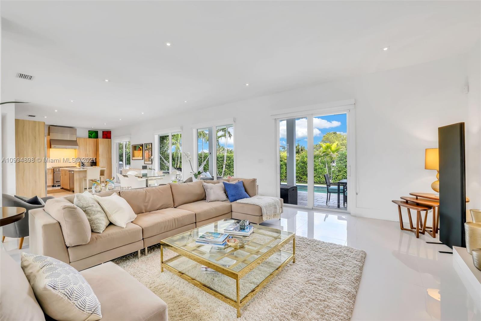 12565 Palm Road North Miami, FL 33181 - Photo 12 of 75 a living room with furniture potted plant and a large window