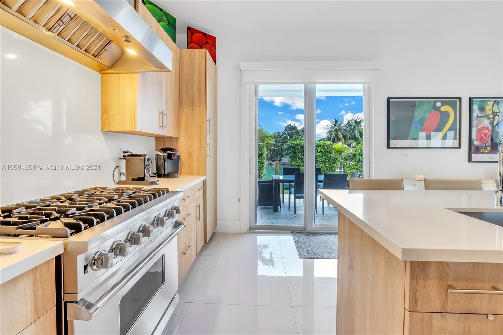 12565 Palm Road North Miami, FL 33181 - Photo 17 of 75 a kitchen with stainless steel appliances granite countertop a stove a sink and a refrigerator