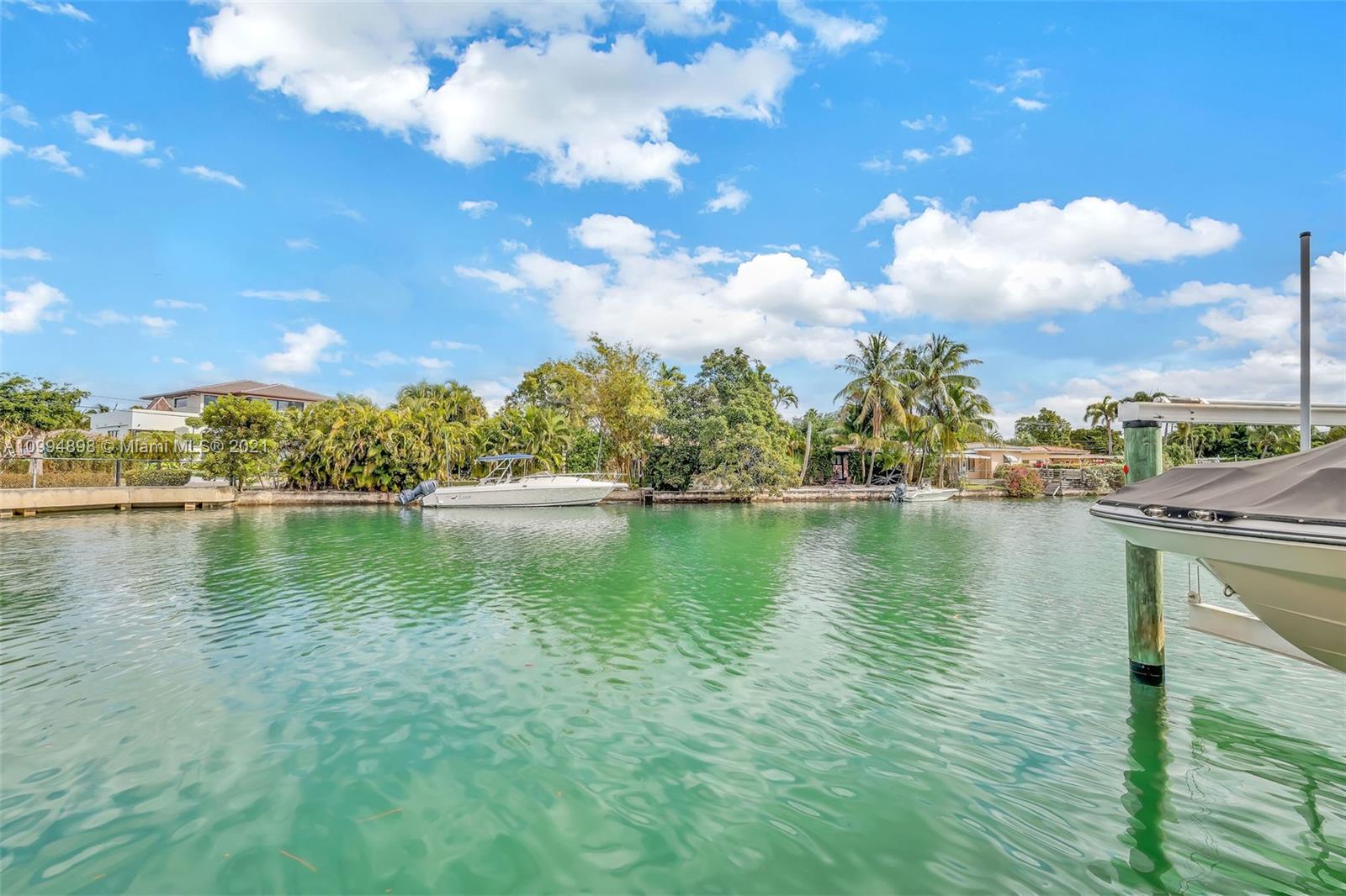 12565 Palm Road North Miami, FL 33181 - Photo 30 of 75 a view of a lake with houses in the background