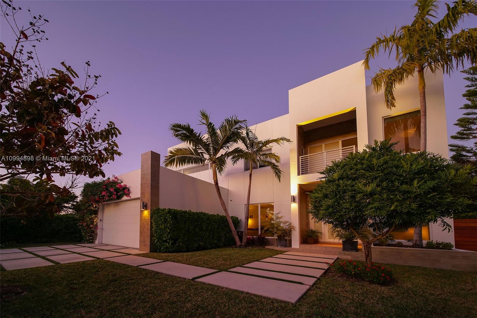 12565 Palm Road North Miami, FL 33181 - Photo 3 of 75 a palm tree sitting in front of a house with a yard