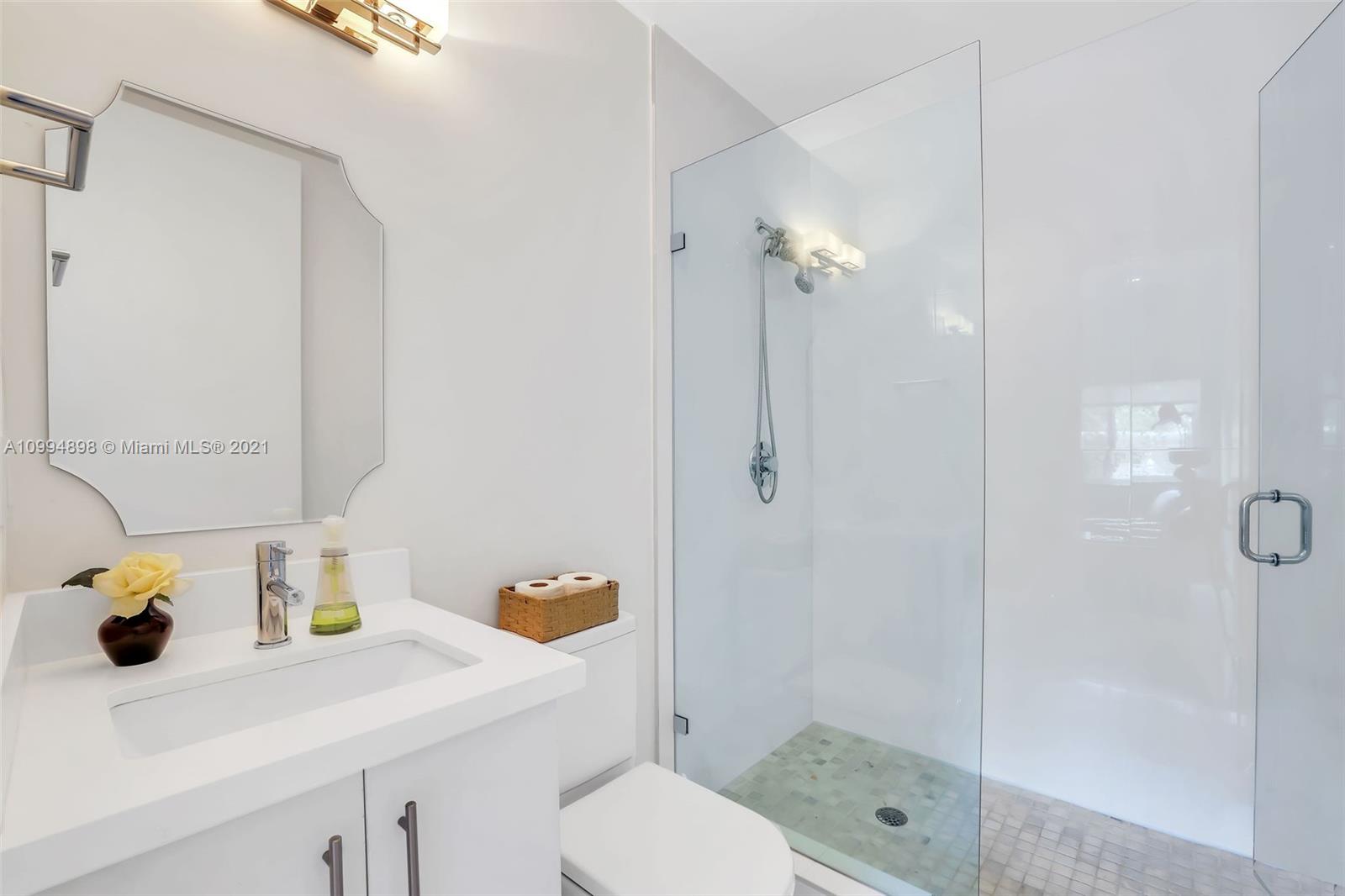 12565 Palm Road North Miami, FL 33181 - Photo 33 of 75 a bathroom with a sink toilet and shower