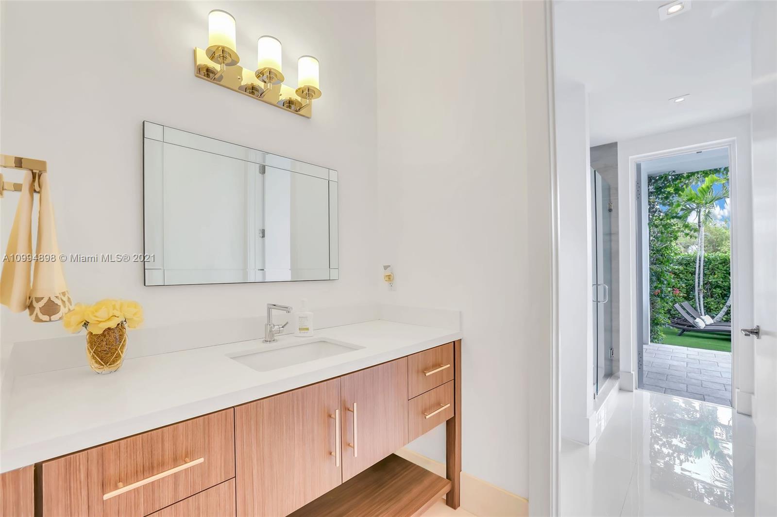 12565 Palm Road North Miami, FL 33181 - Photo 34 of 75 a bathroom with a sink and a mirror