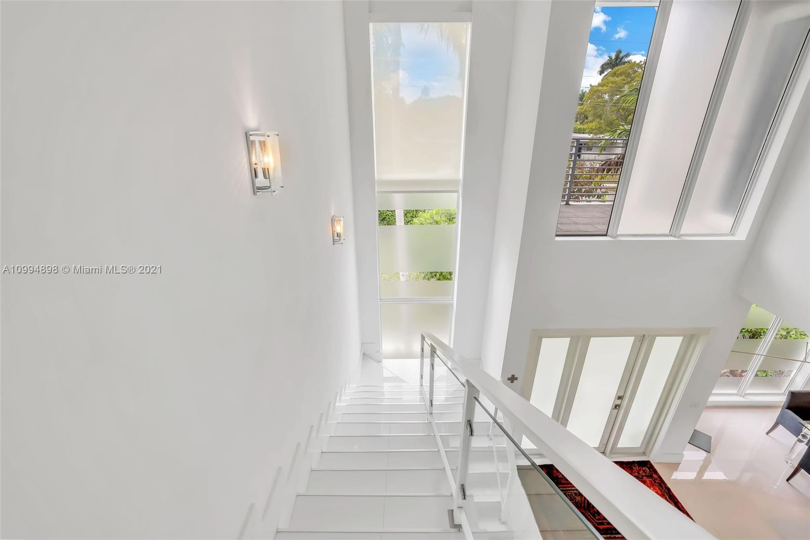 12565 Palm Road North Miami, FL 33181 - Photo 35 of 75 a view of a hallway with wooden floor and staircase