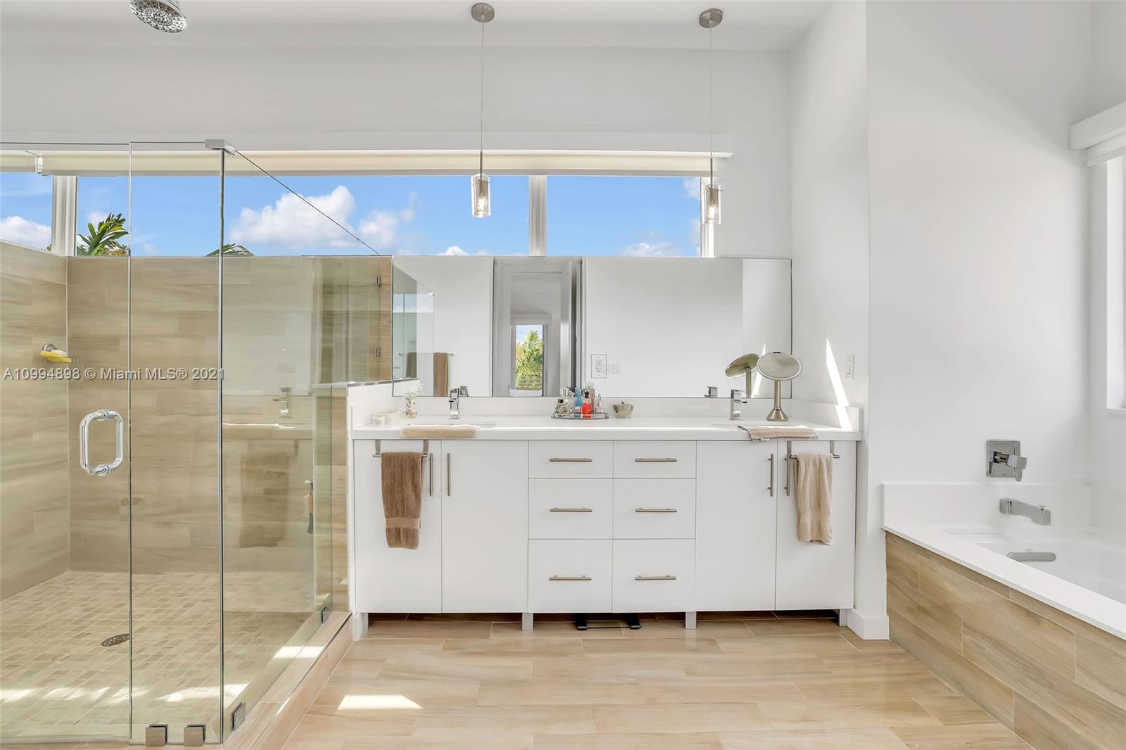 12565 Palm Road North Miami, FL 33181 - Photo 43 of 75 a bathroom with a double vanity sink mirror and shower
