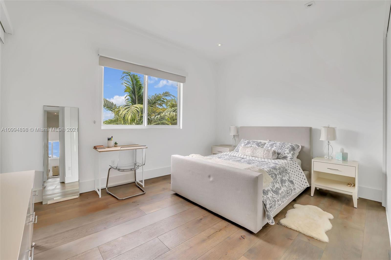 12565 Palm Road North Miami, FL 33181 - Photo 46 of 75 a bedroom with a bed and a desk