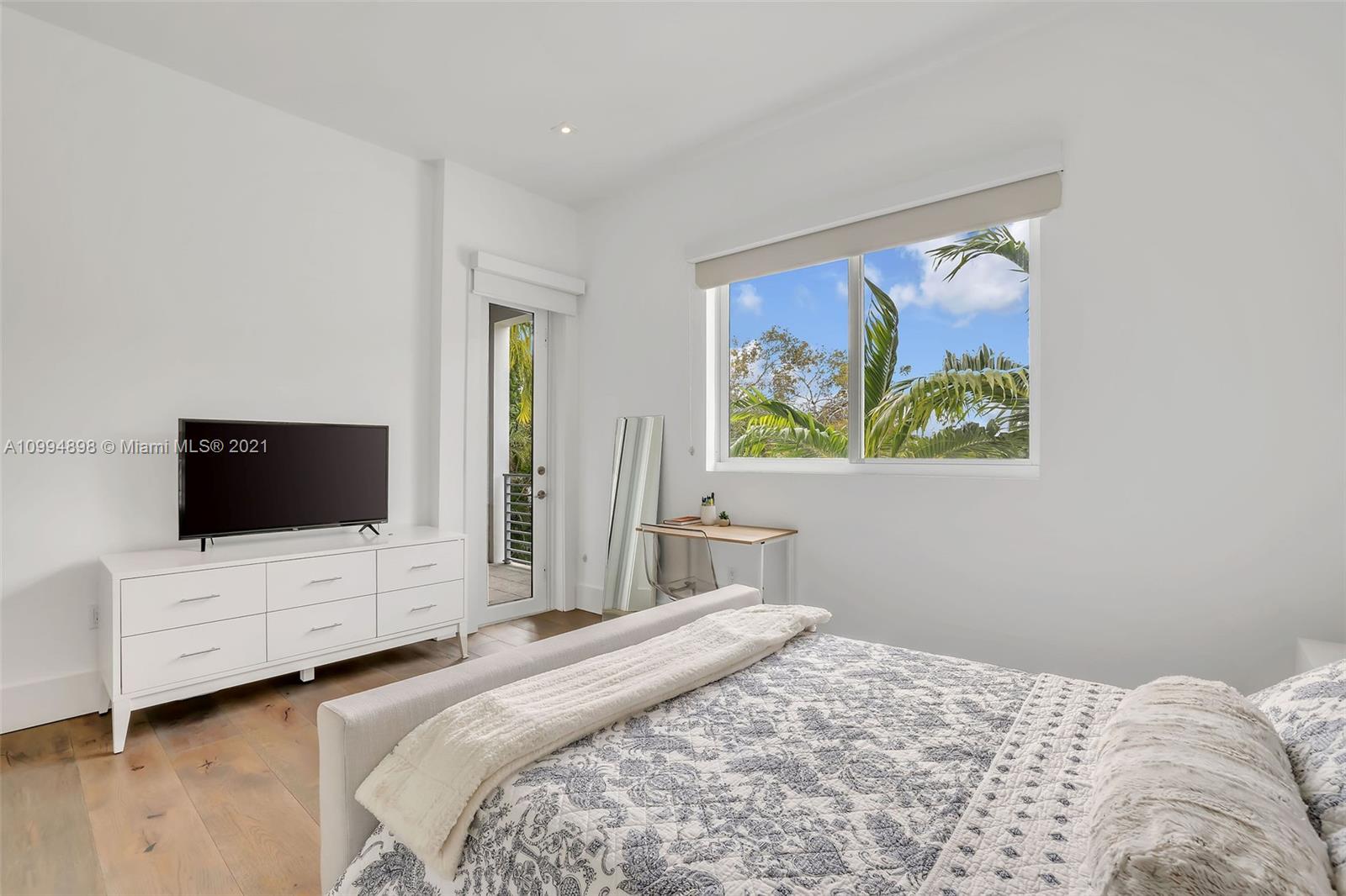 12565 Palm Road North Miami, FL 33181 - Photo 47 of 75 a bedroom with a bed and a flat screen tv