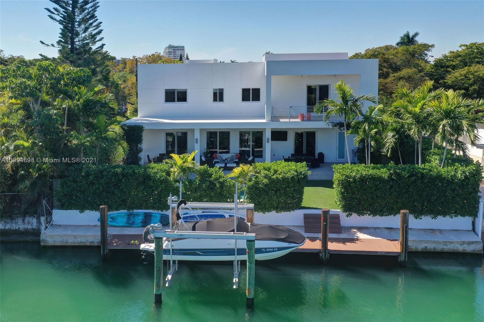12565 Palm Road North Miami, FL 33181 - Photo 5 of 75 a view of a house with a yard and sitting area