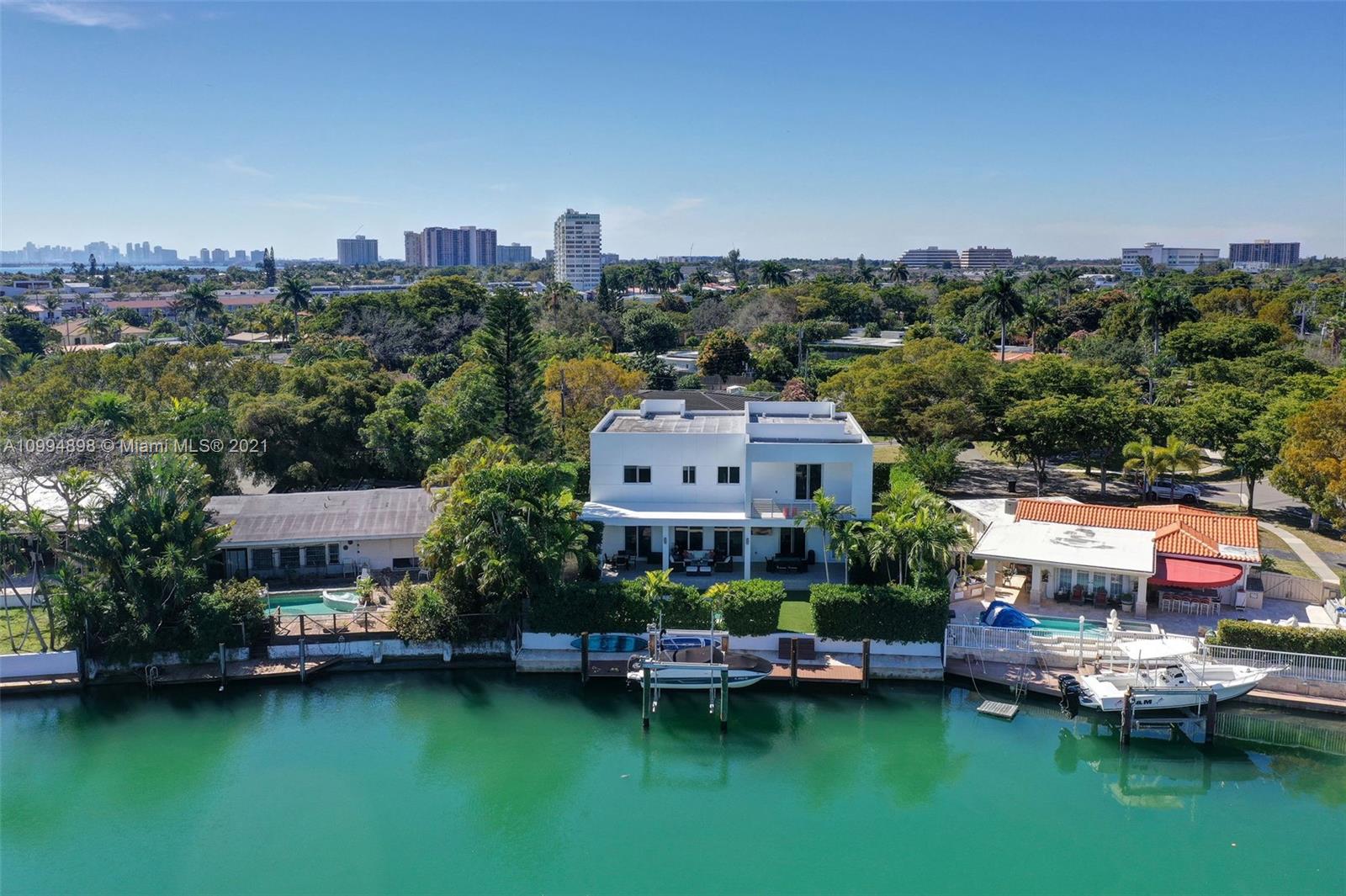 12565 Palm Road North Miami, FL 33181 - Photo 61 of 75 an aerial view of a house with a garden and lake view
