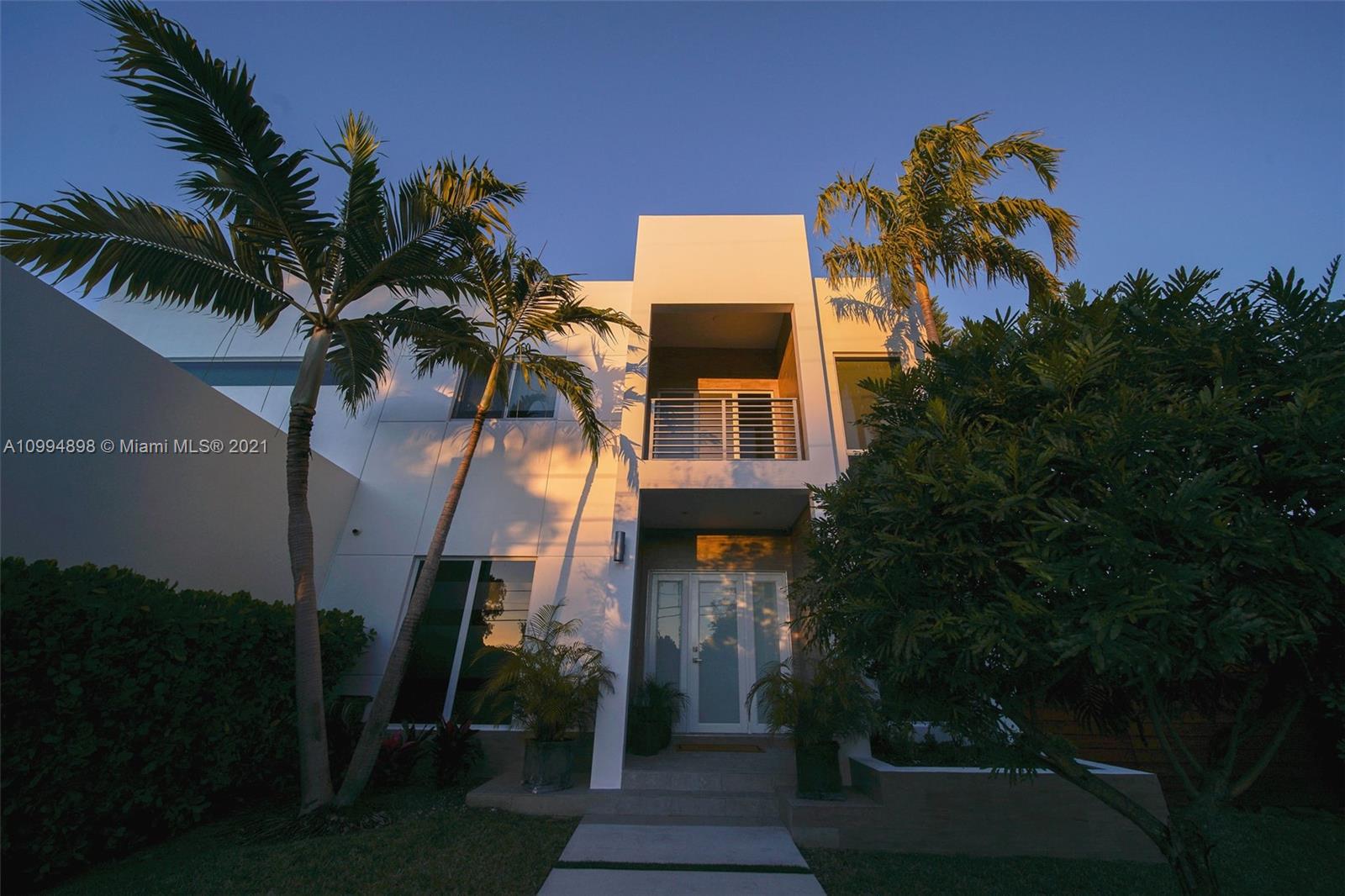 12565 Palm Road North Miami, FL 33181 - Photo 64 of 75 a view of a house with a yard and potted plants