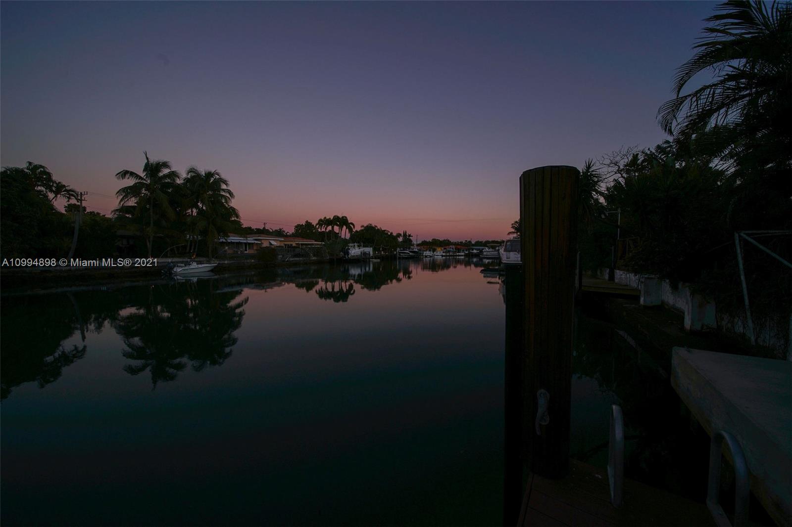 12565 Palm Road North Miami, FL 33181 - Photo 67 of 75 a lake view with boat and palm trees