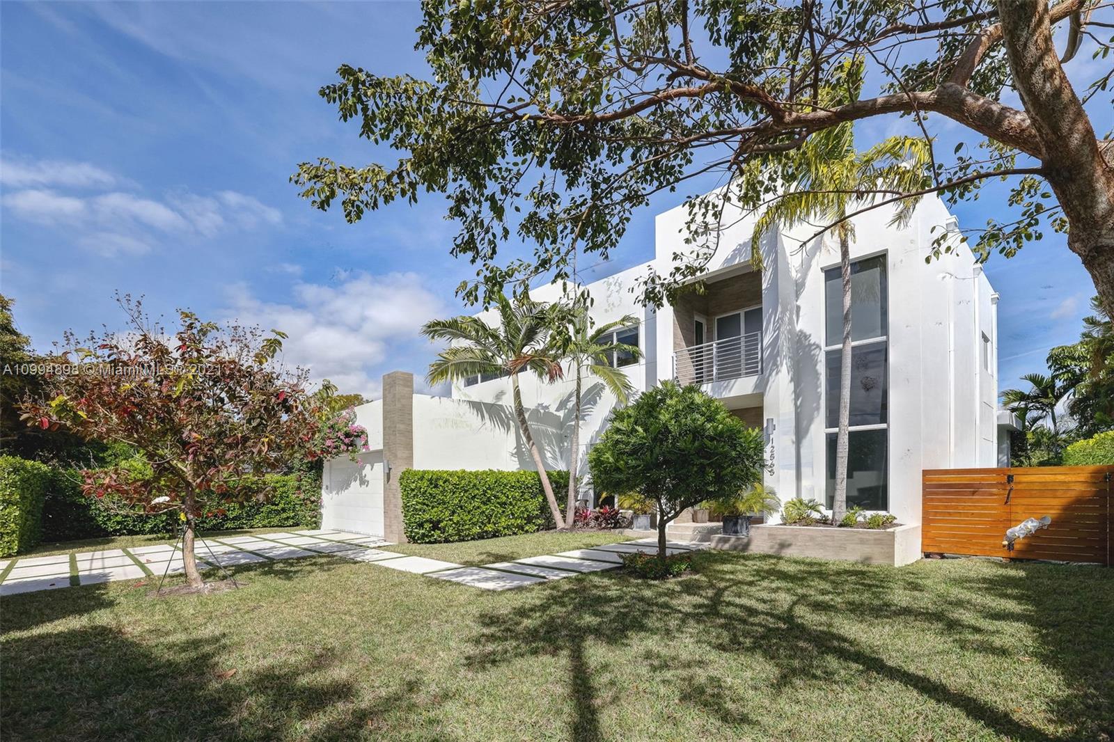 12565 Palm Road North Miami, FL 33181 - Photo 7 of 75 a house that has a tree in front of it