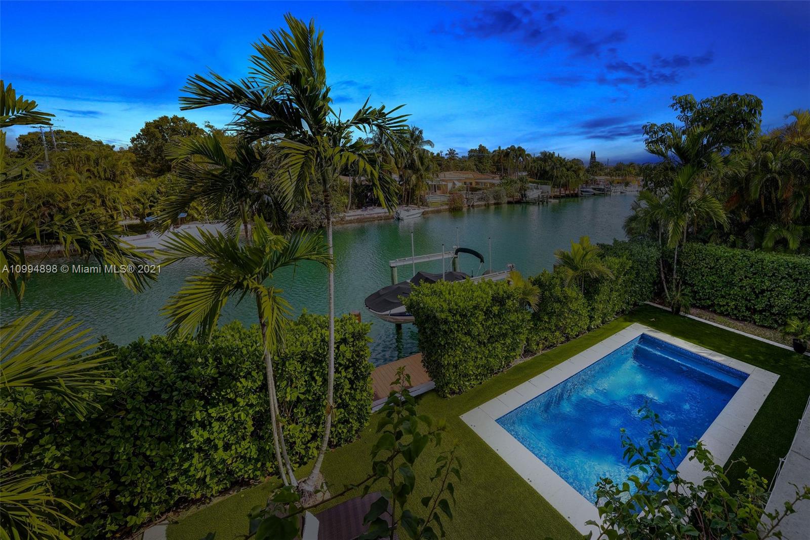 12565 Palm Road North Miami, FL 33181 - Photo 74 of 75 a view of a backyard with plants and lake view