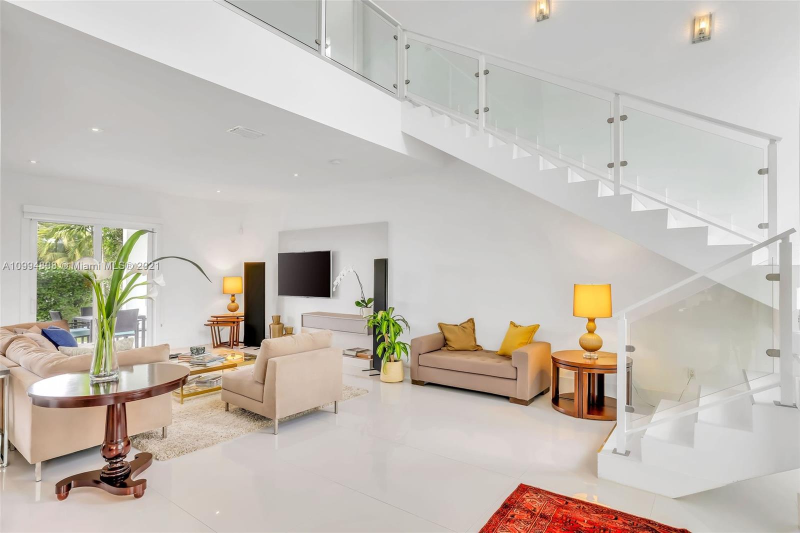 12565 Palm Road North Miami, FL 33181 - Photo 9 of 75 a living room with furniture and a flat screen tv