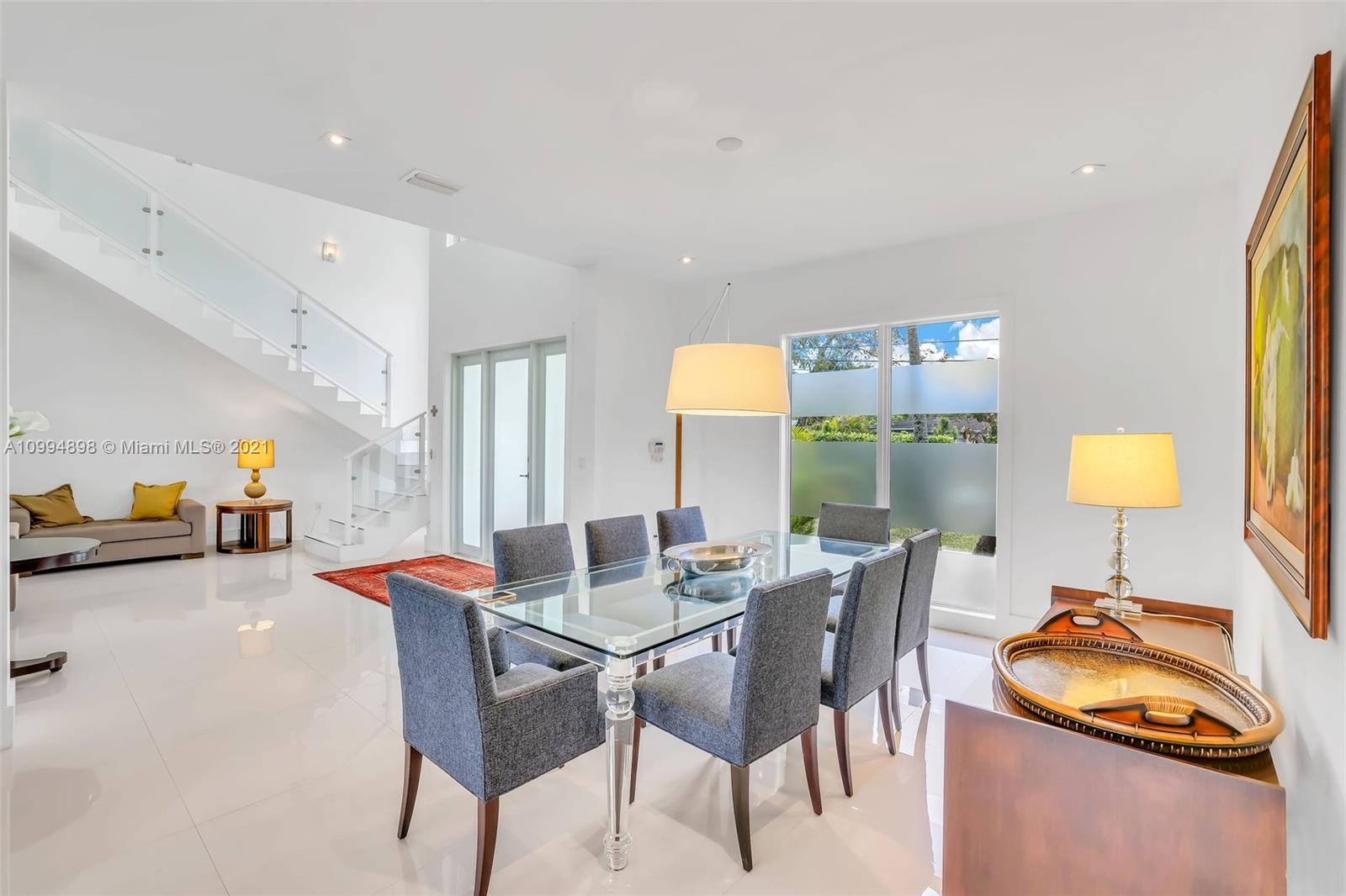 12565 Palm Road North Miami, FL 33181 - Photo 10 of 75 a view of a dining room with furniture and a chandelier