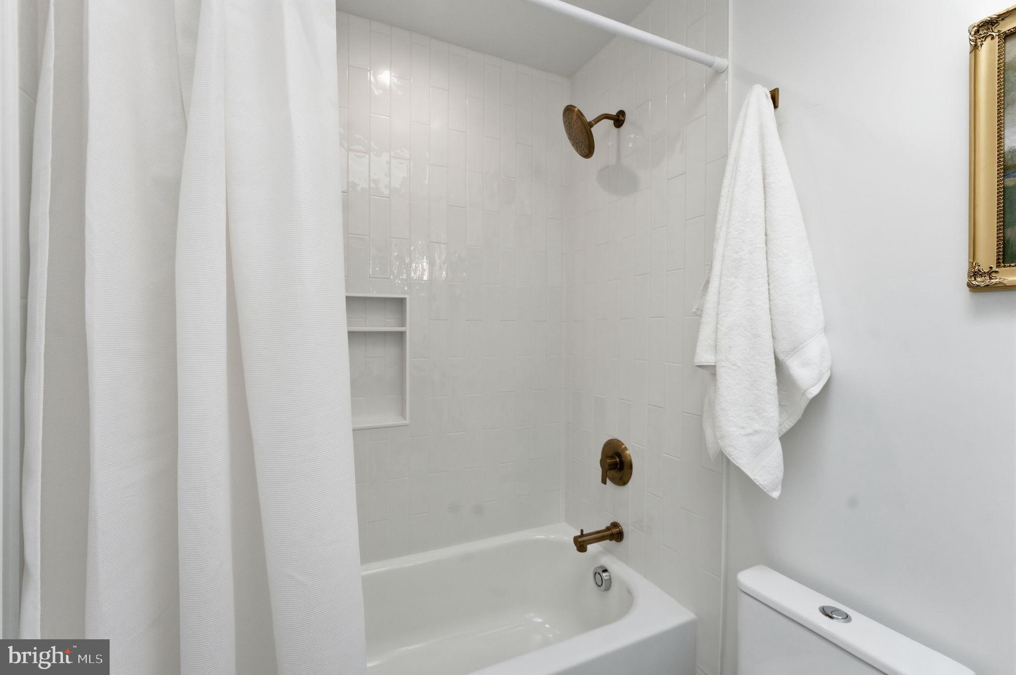 8615 Kerry Lane Springfield, VA 22152 - Photo 26 of 50 a bathroom with a bathtub a shower and a sink