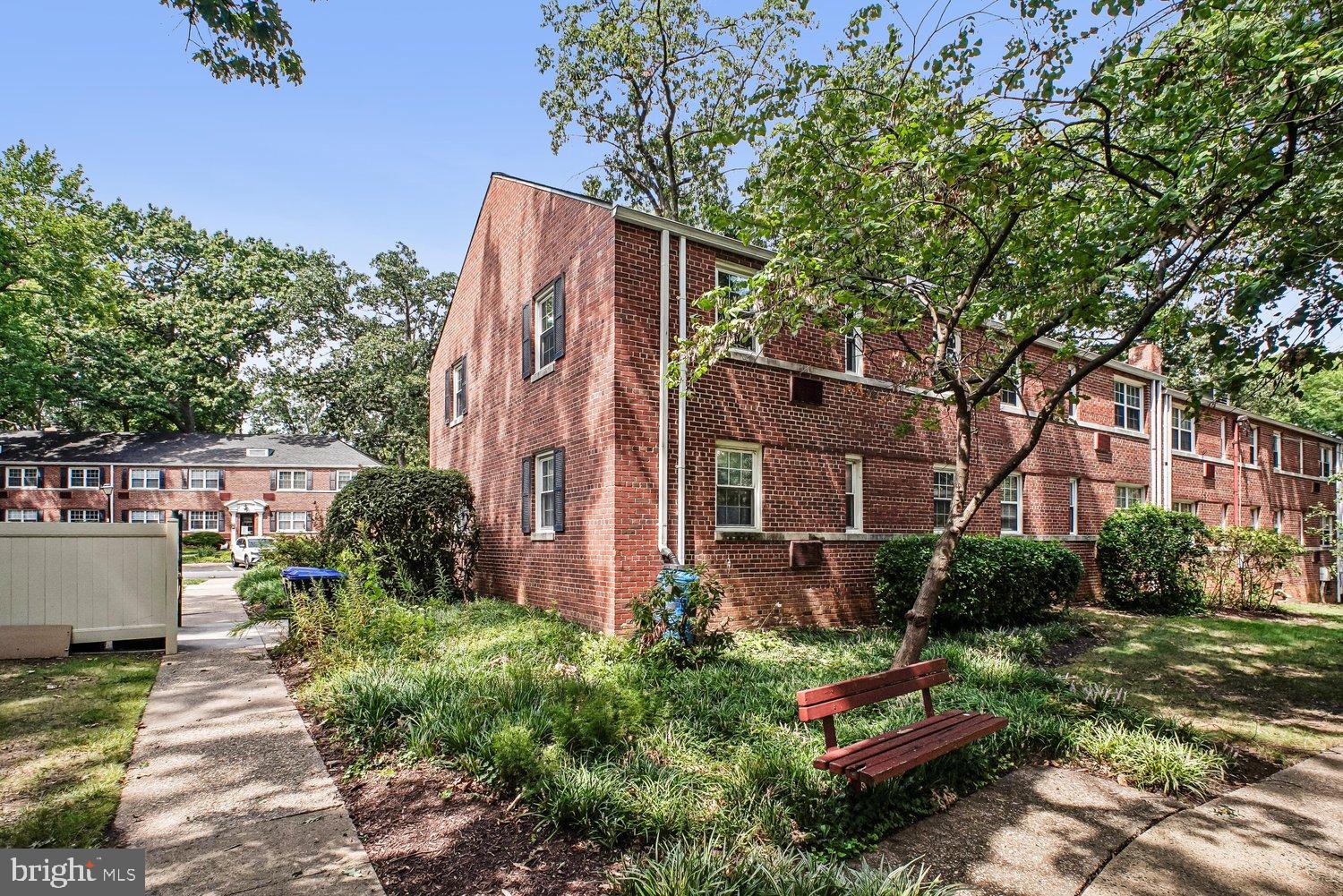 4312 2nd Road North, Unit 2 Arlington, VA 22203 - Photo 2 of 66 Charming brick residence amidst lush greenery.
