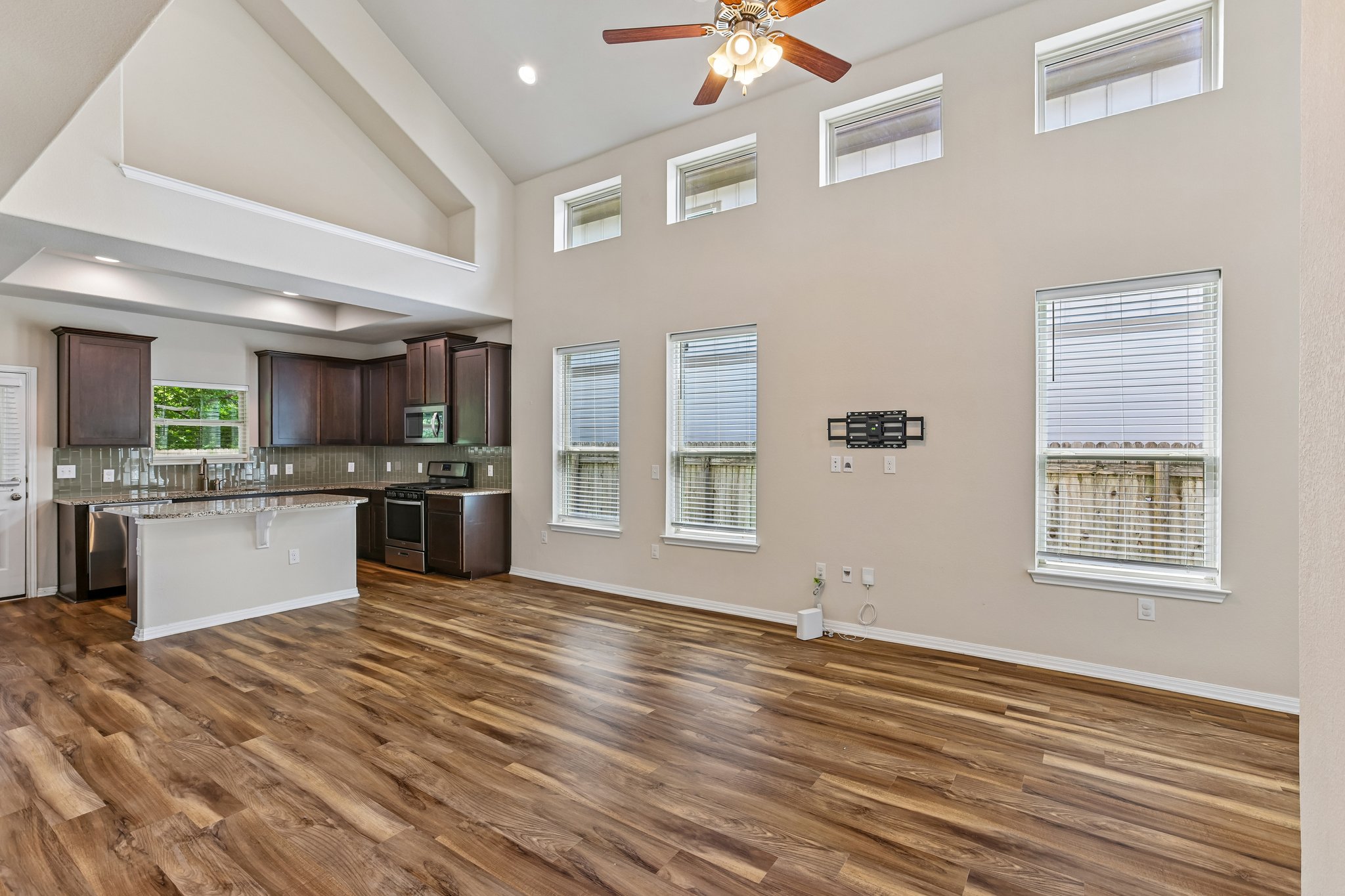 808 Totis Road Austin, TX 78748 - Photo 7 of 40 Expansive living area with high vaulted ceilings and wood-finish flooring