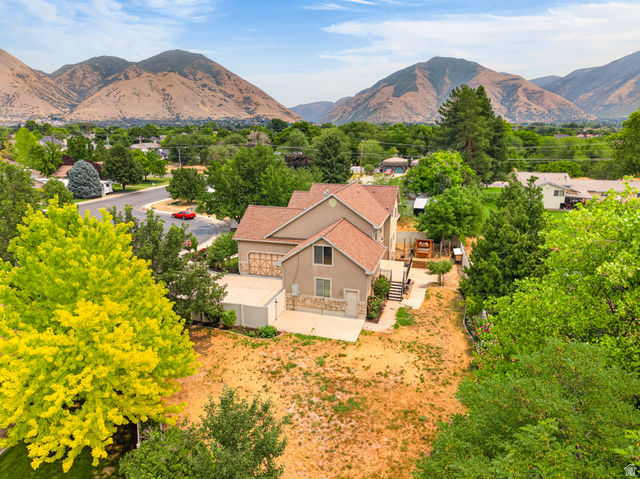 1279 West 1500th Street North Mapleton, UT 84664 - Photo 66 of 83 Two-story residence featuring a two-car garage with decorative doors and a stone-clad foundation