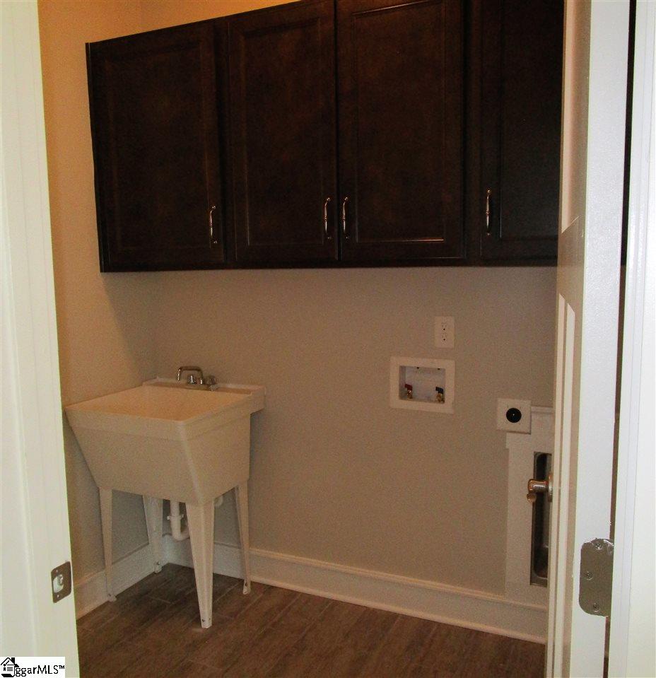 4 Longfellow Way Simpsonville, SC 29681 - Photo 21 of 36 Laundry room with a utility sink and cabinets doubles as a mud room connecting the garage to the home entrance