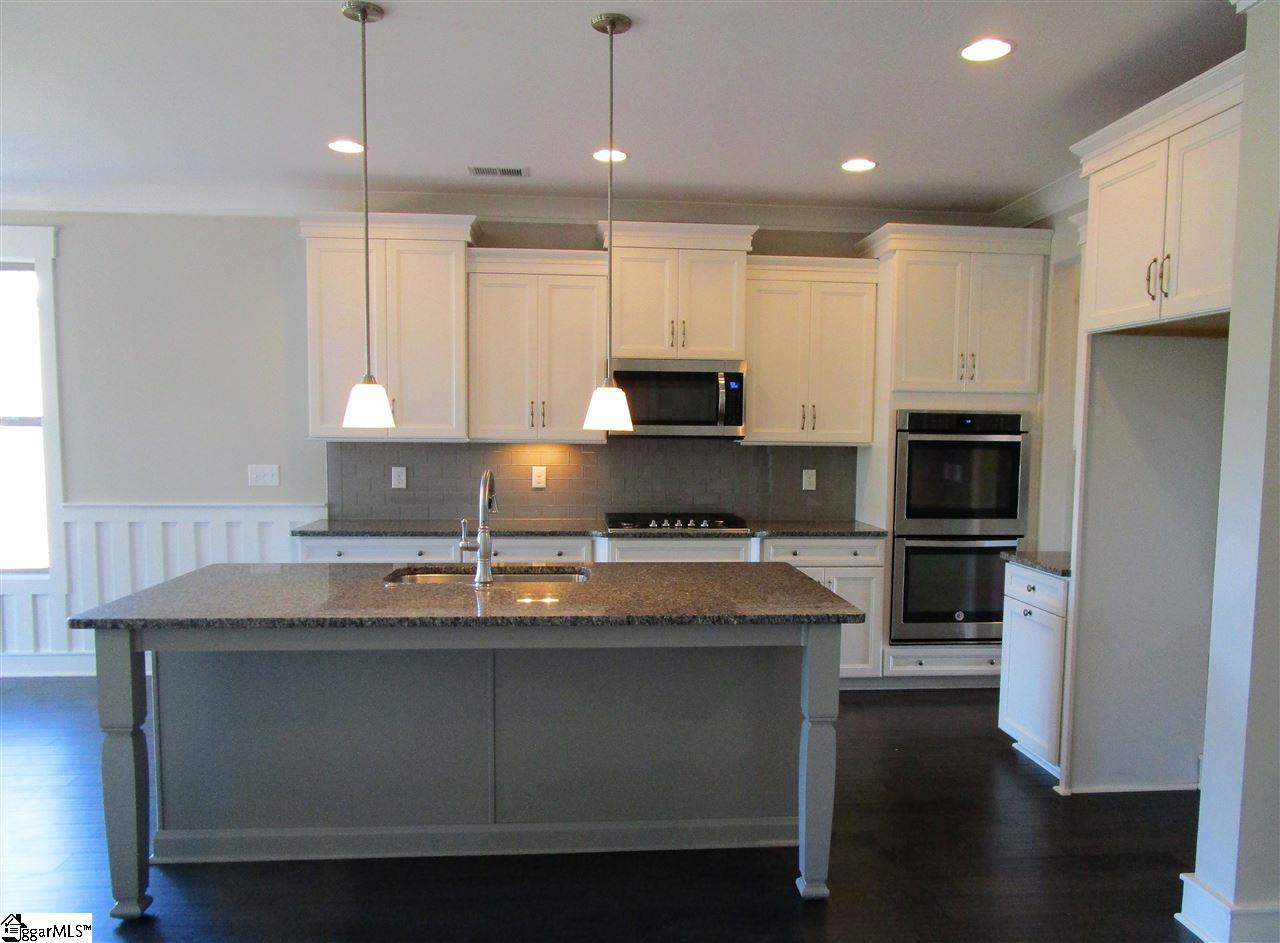 4 Longfellow Way Simpsonville, SC 29681 - Photo 10 of 36 Staggered, two-tone cabinetry with crown molding, roll out trays, and brushed nickel pulls make this kitchen POP