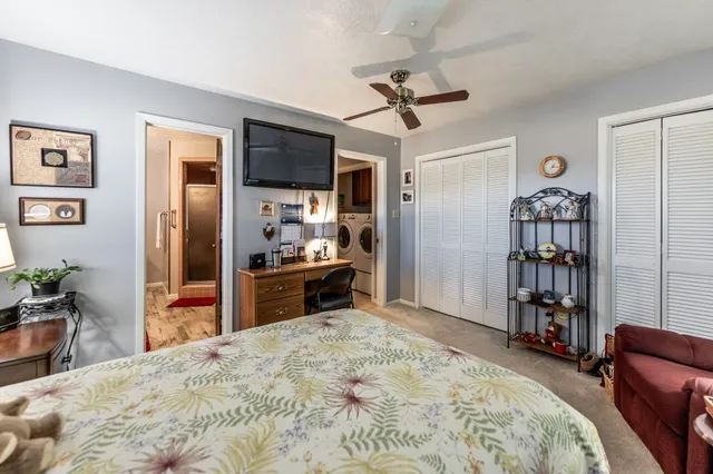 a view of a chairs on wooden deck and lake view