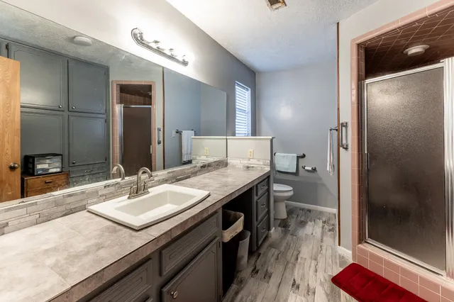 a bathroom with a sink double vanity and a mirror