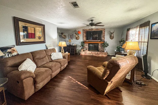 a living room with furniture fireplace and a window